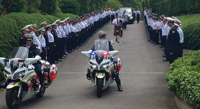 Members of the NSW Ambulance Motorcycle Response Unit leading a funeral procession