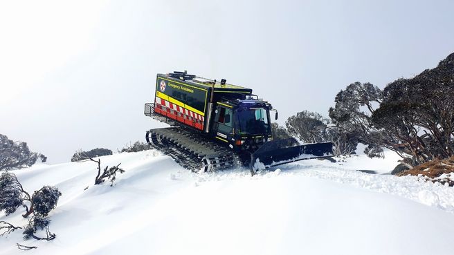 The NSW Ambulance oversnow rescue Kassbohrer vehicle travelling through the Australian Alps to meet rescuers.
