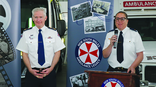 A photo of Michelle Stokes of Ambulance Legacy and Chief Executive Dr Dominic Morgan speaking at a special event to honour the service of former NSW Ambulance Riverina staff at the Temora Ambulance Museum on 22 October 2022. 