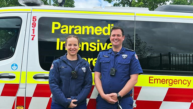 Wagga Wagga Paramedics Amy Barclay and Charles Milne pose for a photo in front of a NSW Ambulance vehicle wearing Body Worn Cameras (BWC). A trial of the cameras has recently been expanded to paramedics in Artarmon, Northmead and Wagga Wagga