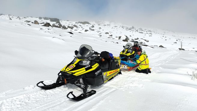 Station Officer Paul Taylor of NSW Ambulance Alpine Operations preparing an injured 32 year-old skier for transport from Mt Kosciusko to Perisher in 2022
