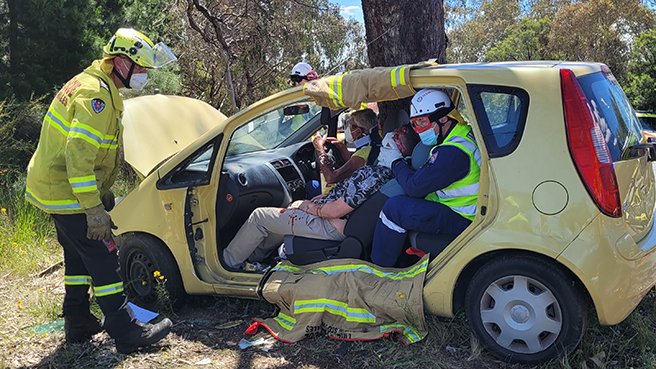 Paramedics and a Fire and Rescue NSW officer treating dummy patients in a road crash training exercise near Queanbeyan on 18 November 2022.