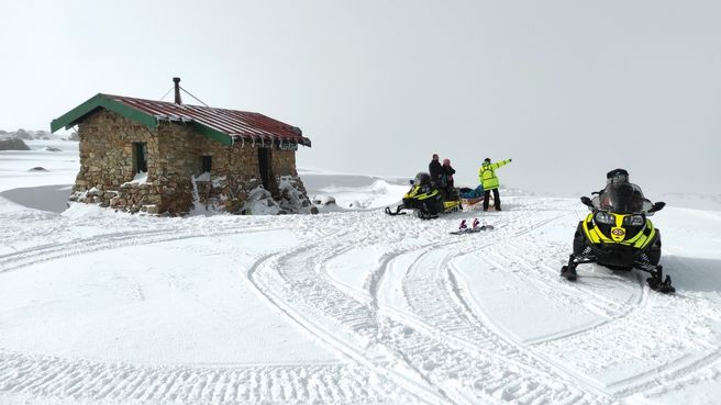Two NSW Ambulance snowmobiles get ready to transport an injured skier from Seaman's Hut near Mt Kosciusko 